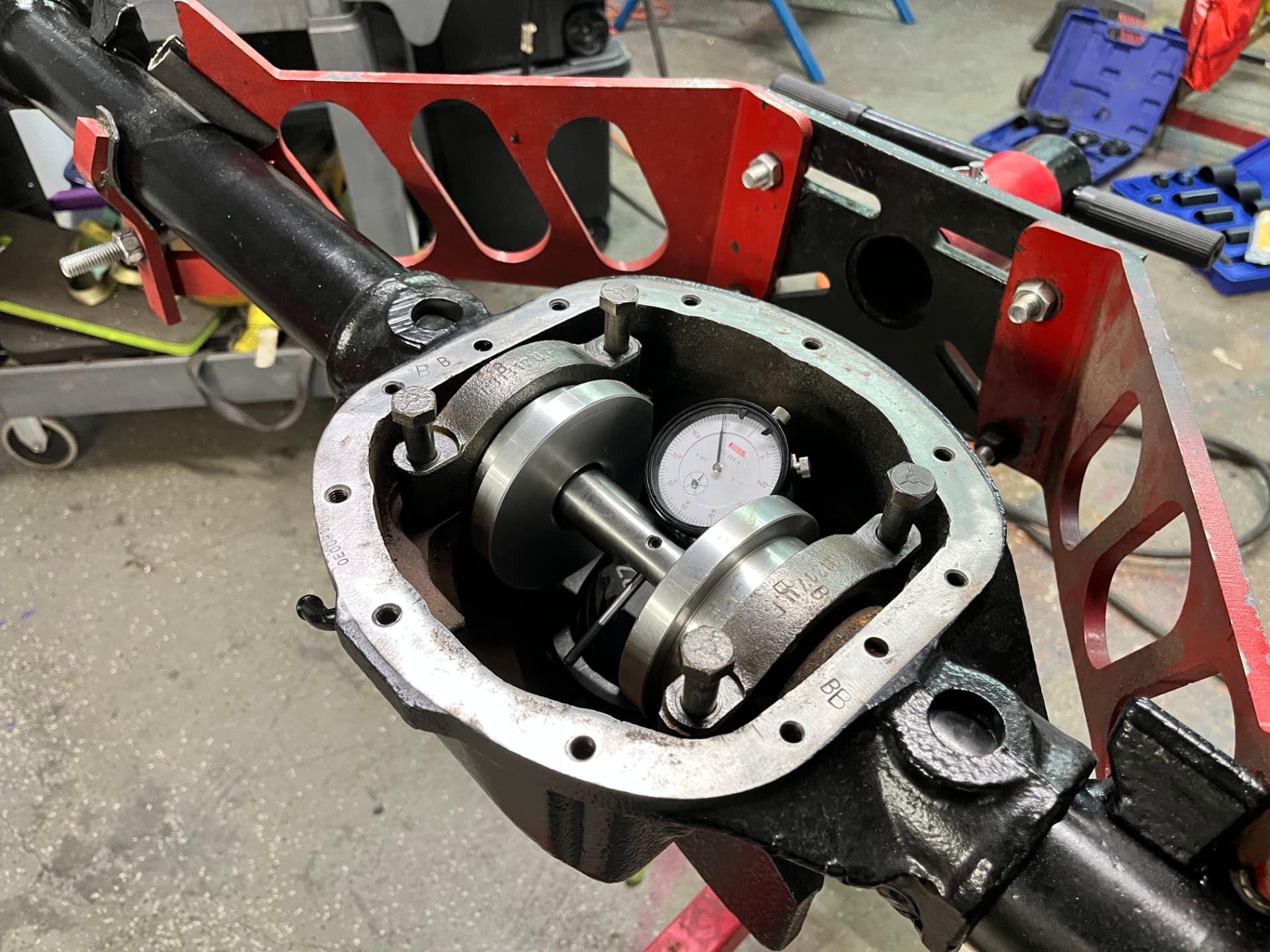 Dial indicator checking axle setup inside an open housing at EFJ